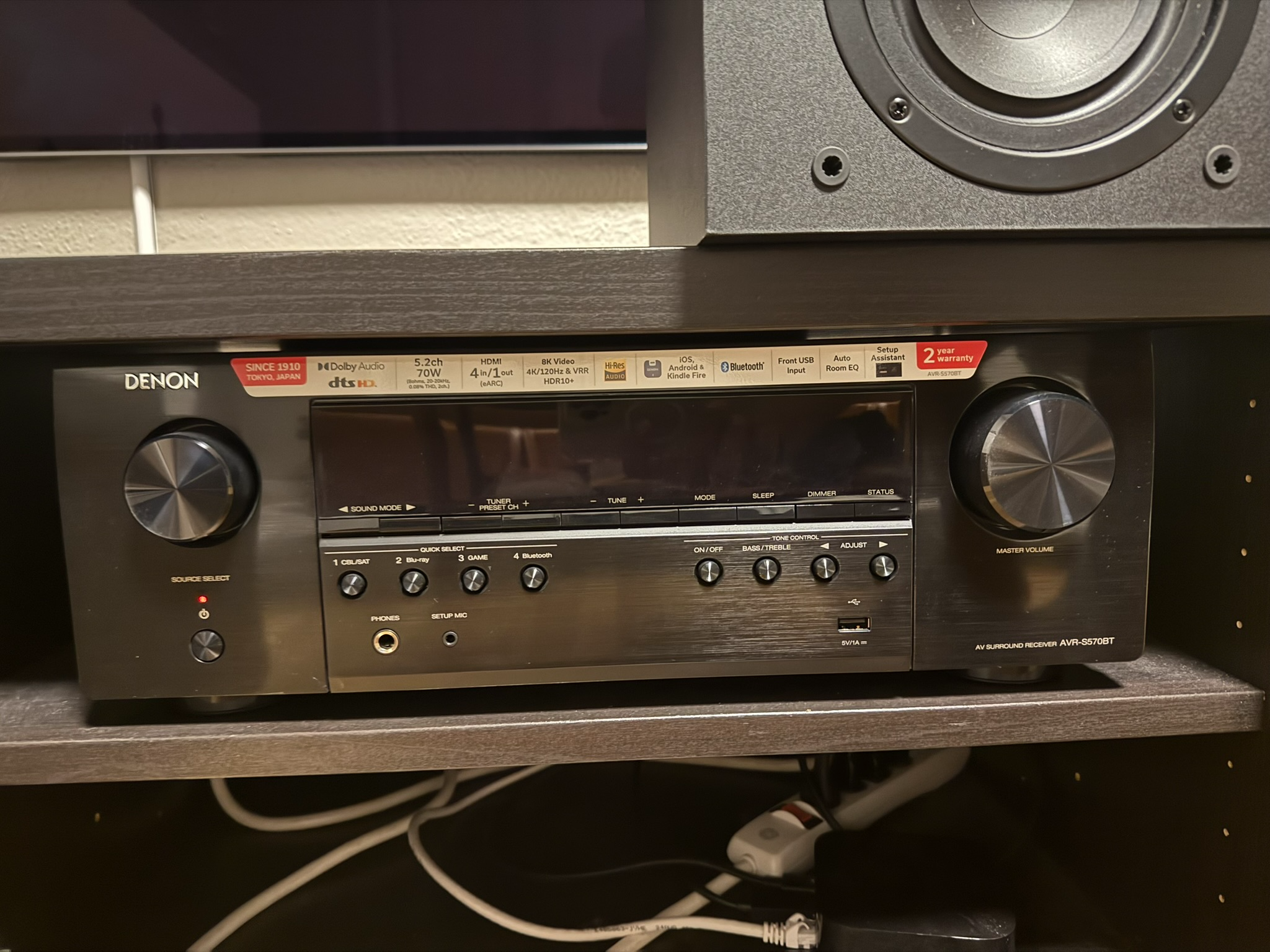 Denon amplifier below the television