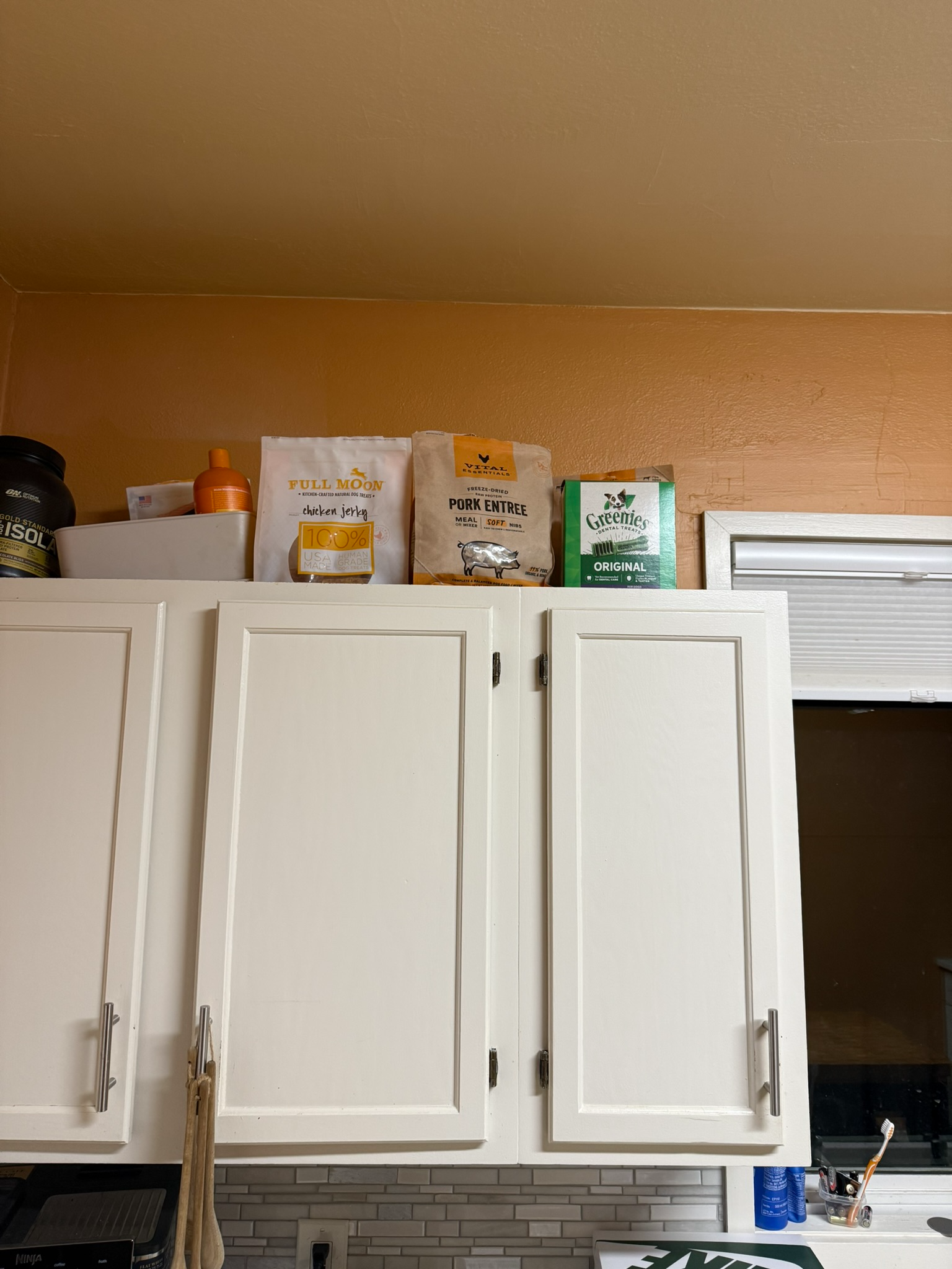 Treats on top of the kitchen cabinet